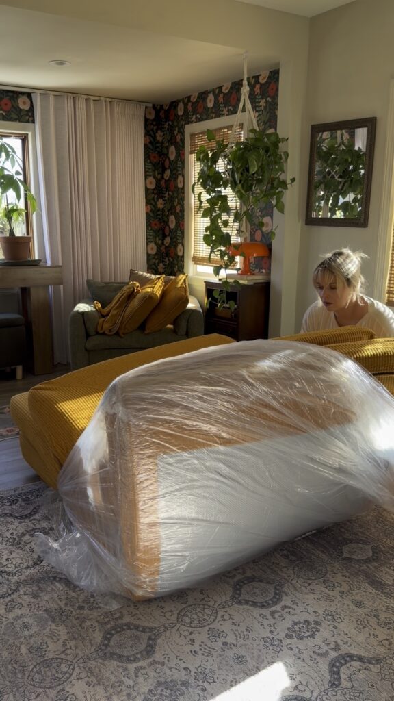 Vacuum-sealed couch expanding after the plastic wrap is cut open
