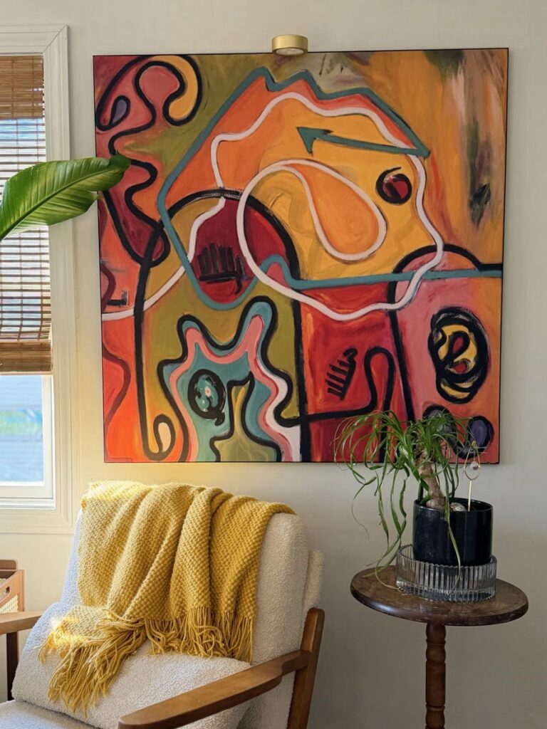 cozy boho living room with large statement wall art and plants
