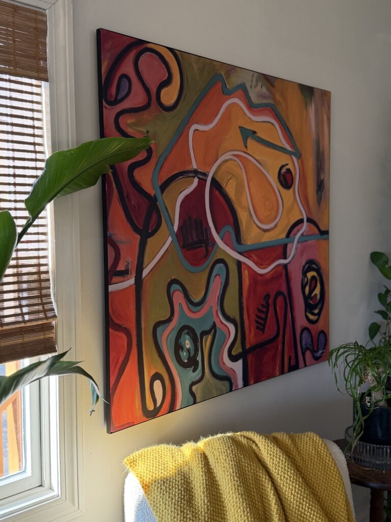 cozy boho living room with large statement wall art and plants
