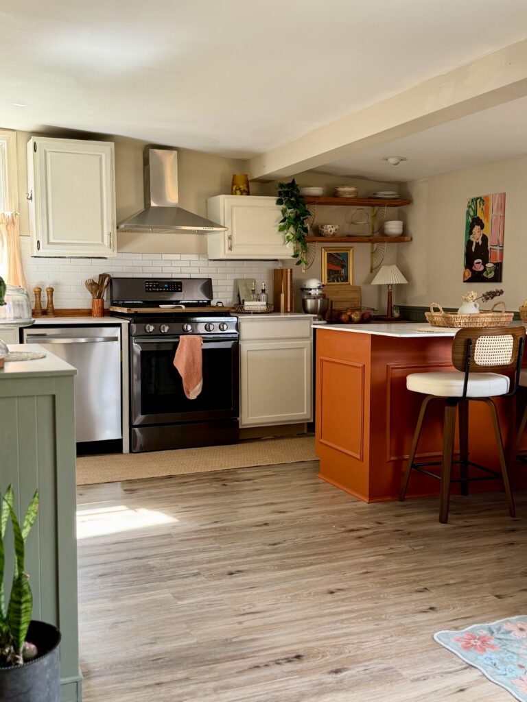 kitchen after transformation with creamy cabinets and orange island