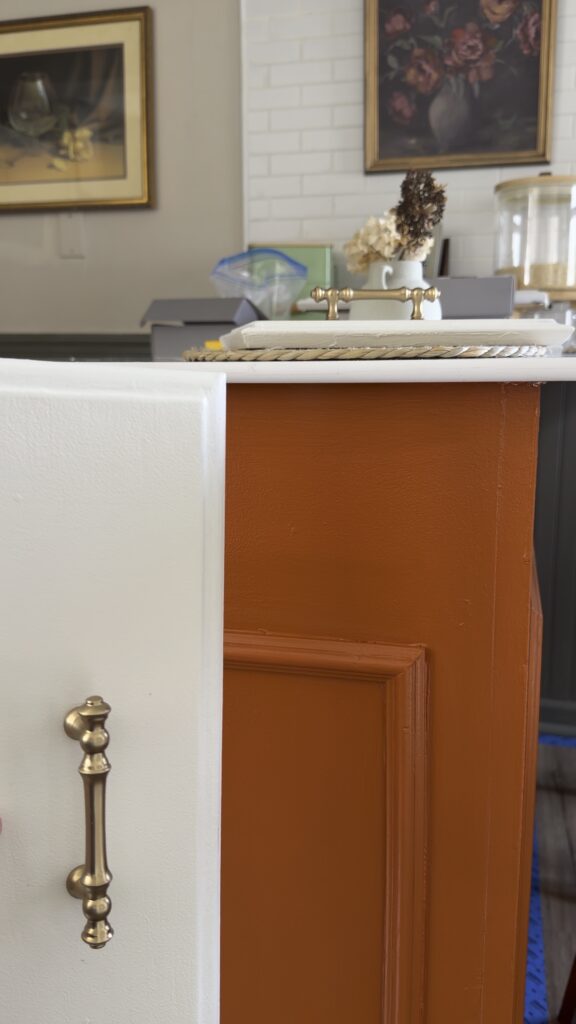 brass cabinet handle close-up on painted kitchen cabinets