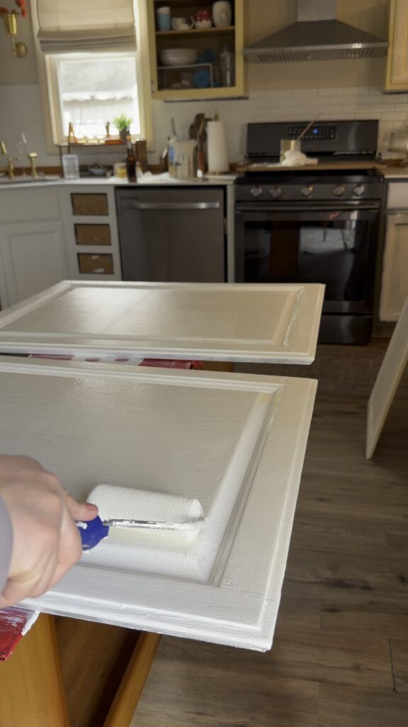 painting kitchen cabinets with roller white creamy paint