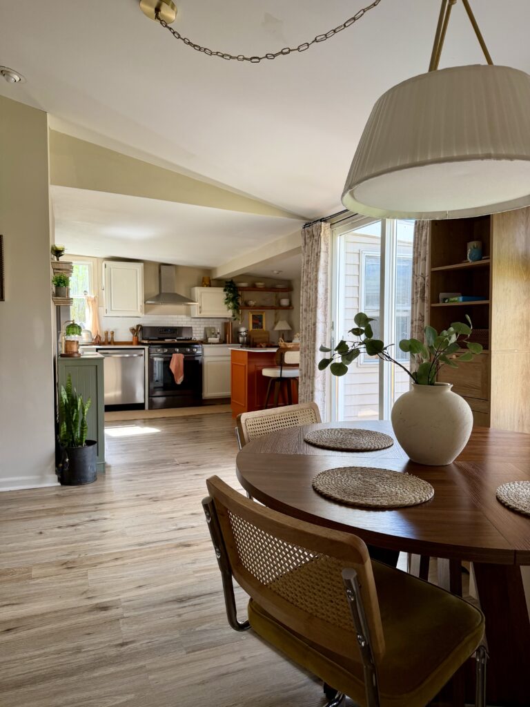 wide view of kitchen and dining area after renovation with warm decor