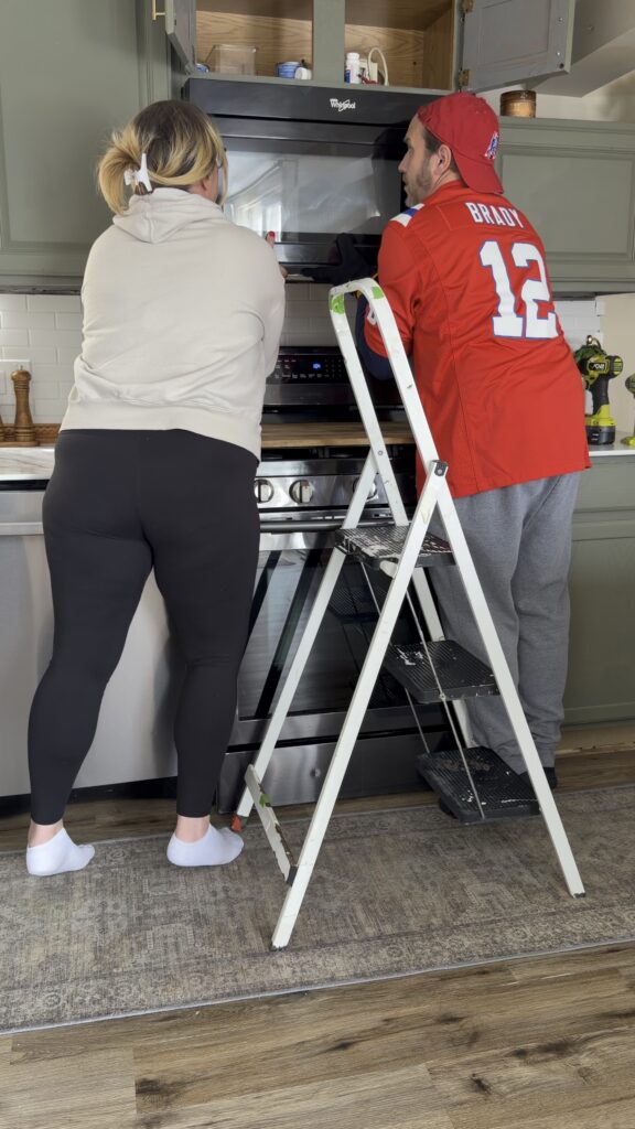 removing over-the-range microwave with ladder kitchen update