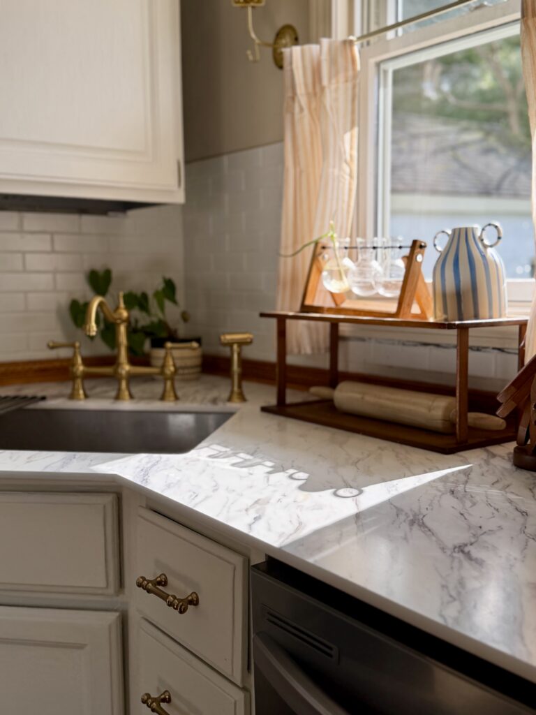 thinscape calcutta marble countertop with kitchen sink and brass faucet